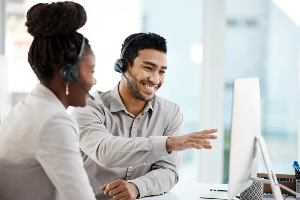 Love what you do. Shot of two colleagues working in a call center Tbourke Solutions business IT support team
