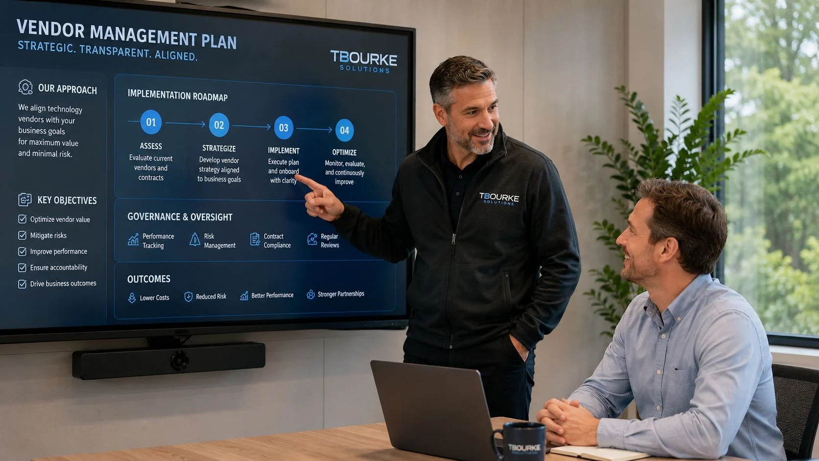 A professional business consultant explains a vendor management plan strategy on a large digital screen to a client.